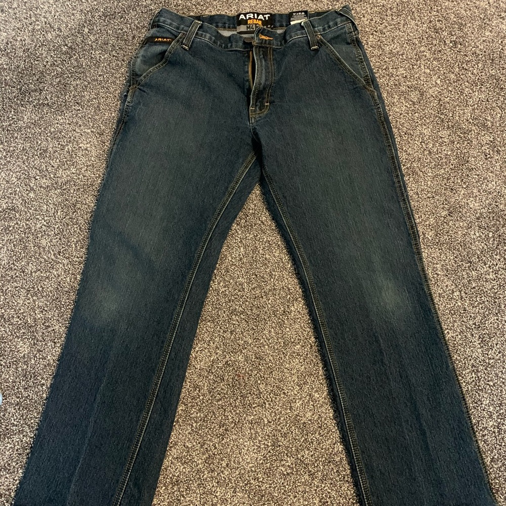 Two pair of Ariat M4 Rebar jeans.